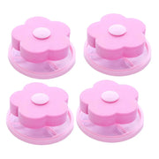 Quatre filtres Nidofé Écume roses, avec dessus en forme de fleur et filets circulaires.