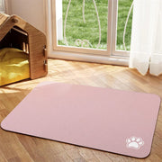 Tapis de repas Nidofé Rive rose, avec motif de patte, posé sur un sol en bois.